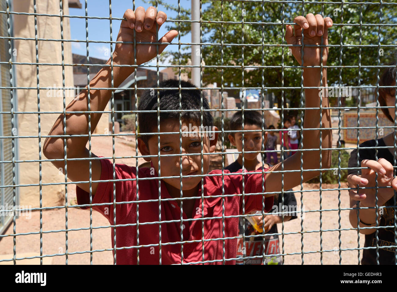 A boy looks into Arizona from Mexico at the border between Naco, Arizona, USA and Naco, Sonora