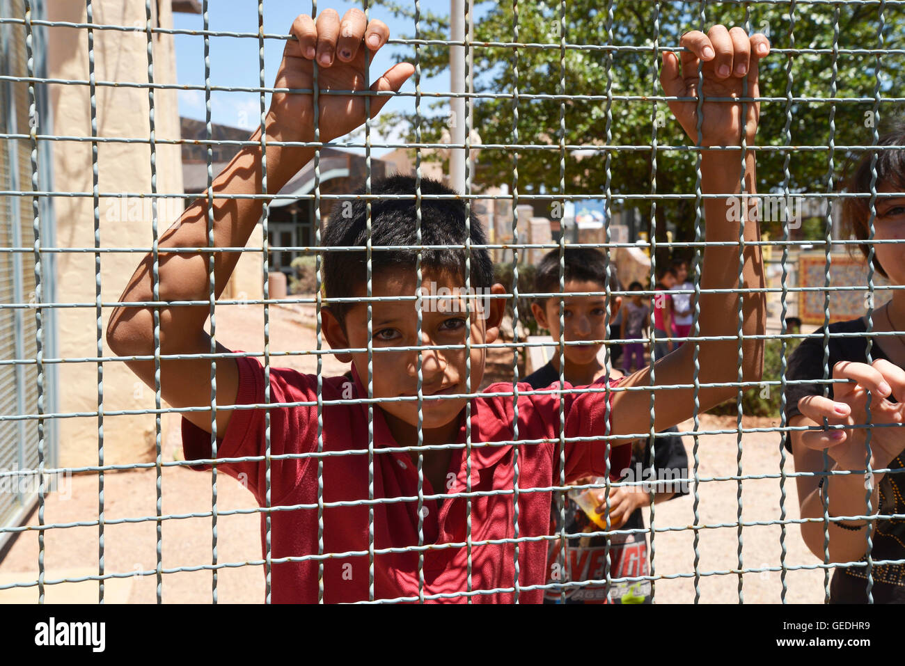 A boy looks into Arizona from Mexico at the border between Naco, Arizona, USA and Naco, Sonora