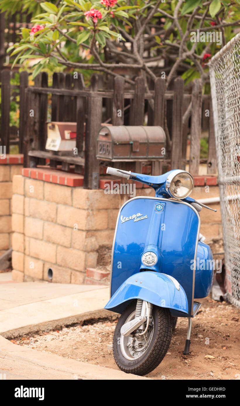 Laguna Beach, CA, USA – July 23, 2016: Blue retro Vespa moped parked in front of a home in Laguna Beach, California Stock Photo