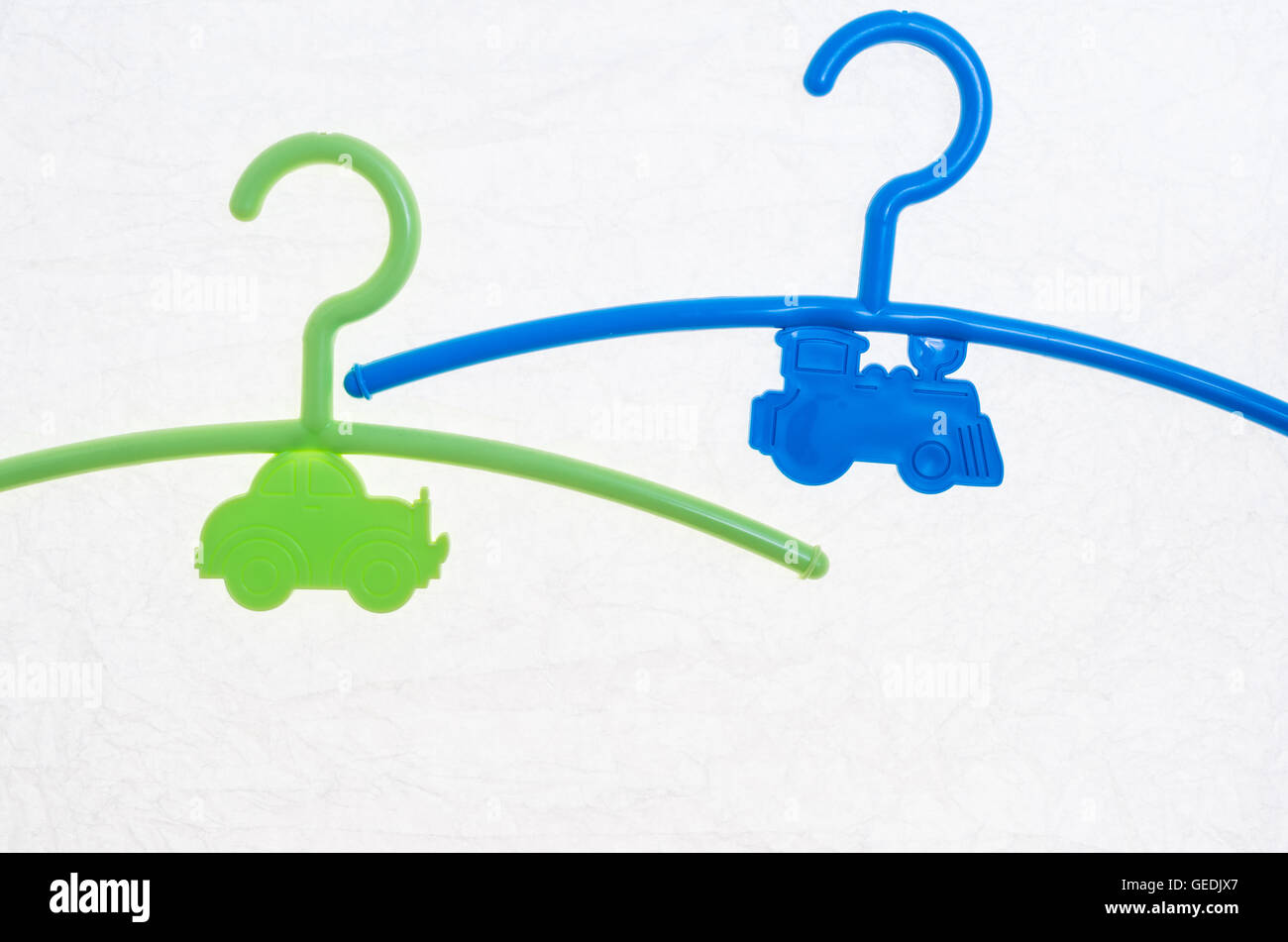 colored hangers for infants clothing on a white background Stock Photo