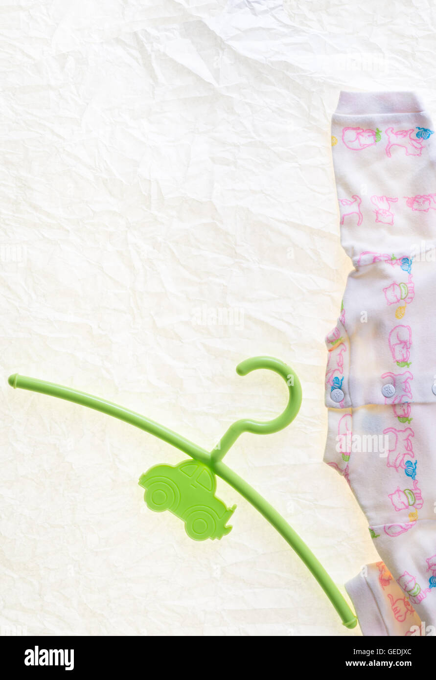 colored hangers for infants clothing on white background Stock Photo
