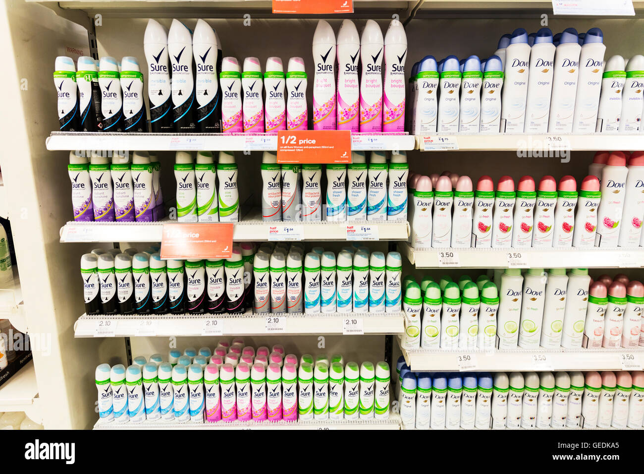 Sure anti perspirant deodorant deodorants tins Dove compressed aerosol cans aerosols  products chemist shop display UK England Stock Photo