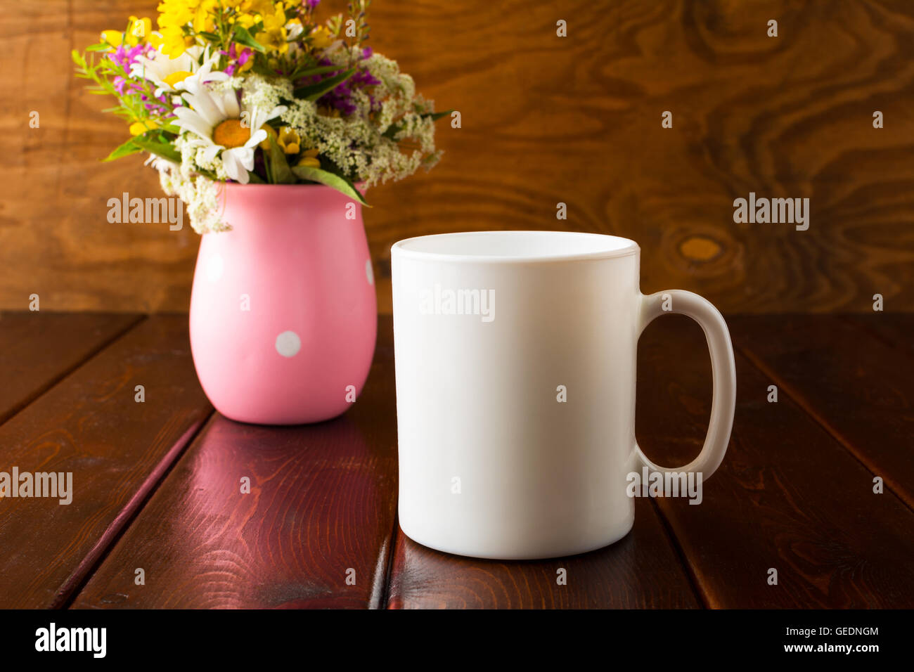 White coffee mug mockup with wild flowers. Empty mug mockup for product presentation. Coffee cup mock-up for promotion brand or Stock Photo