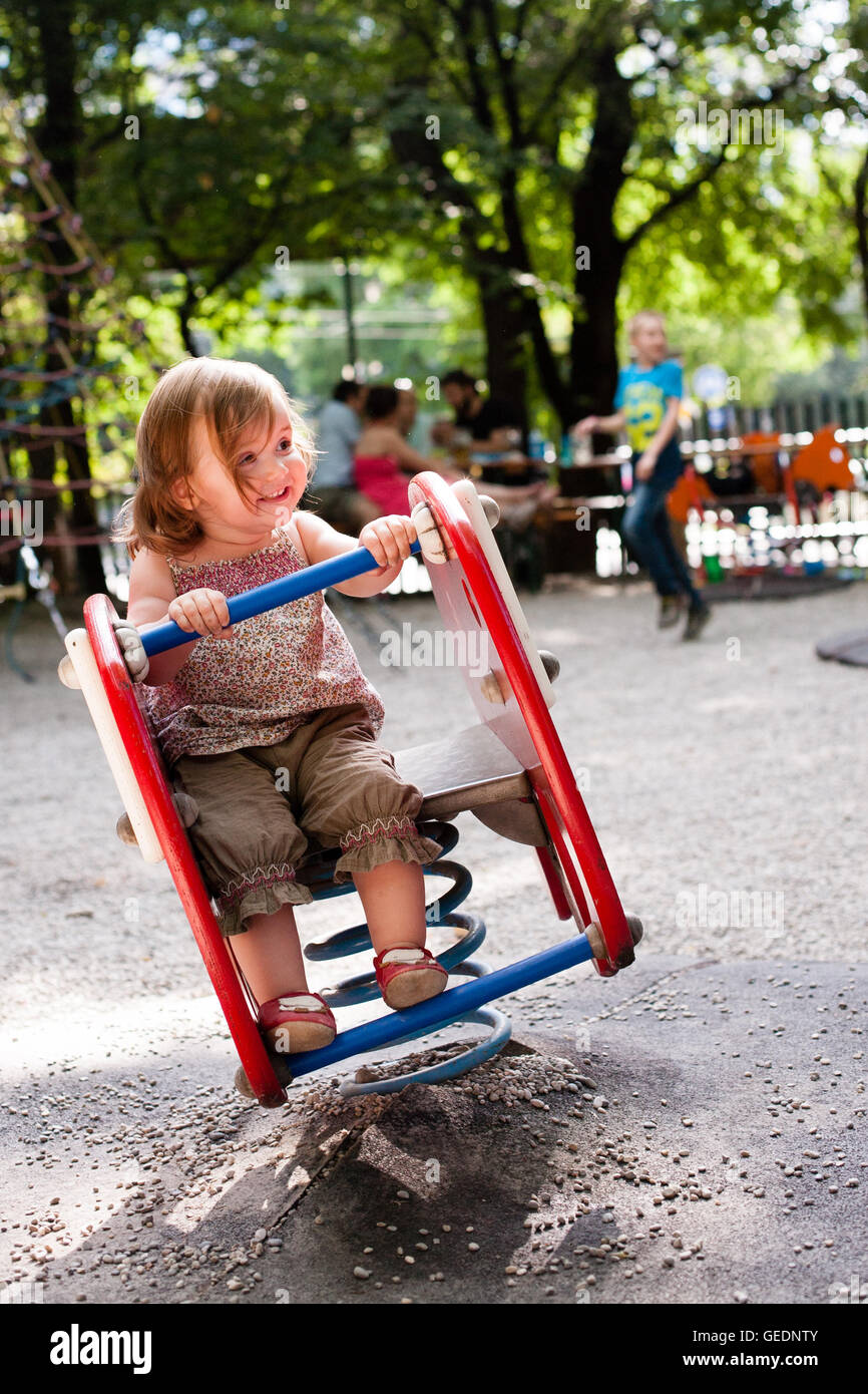 16 month old girl playing in the playground of a beer garden. Stock Photo