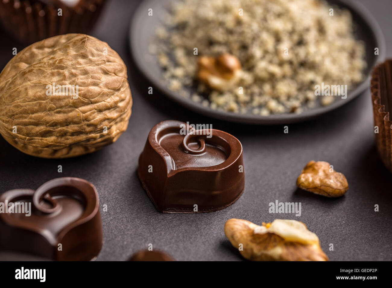 Dark heart shaped chocolate on black background Stock Photo - Alamy