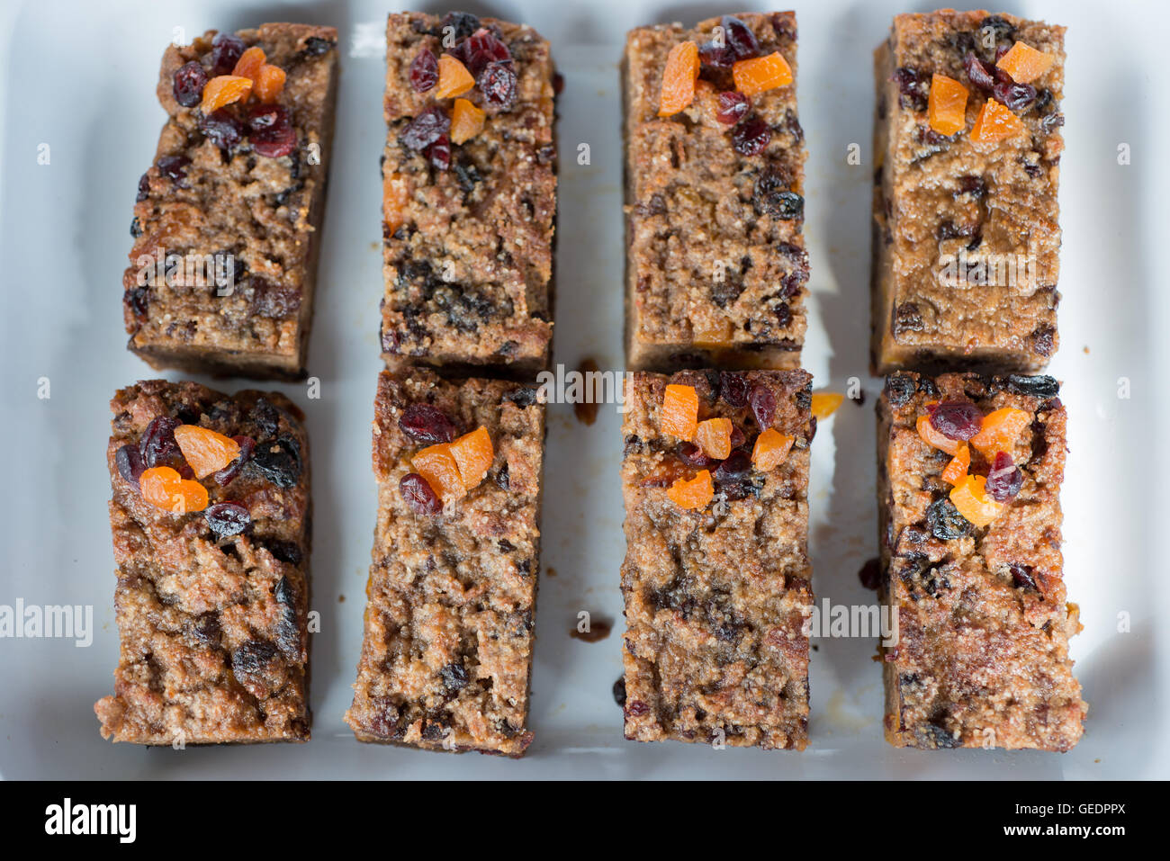 A healthy home made snack of six dried fruit, oat, Granola bars with pieces of dried apricot, raisin, cranberry and toasted oats Stock Photo