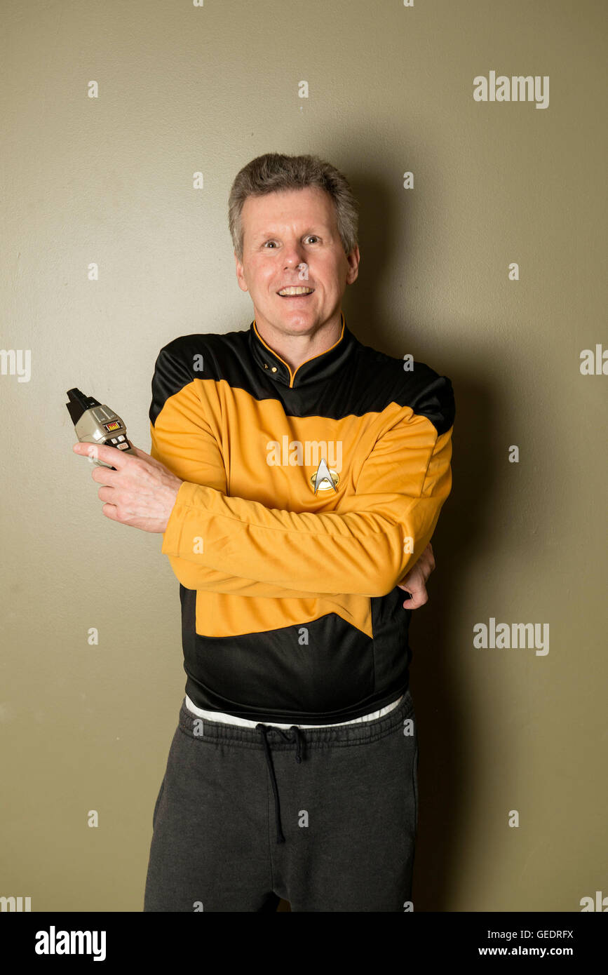 Cosplayer dressed as a crew member of the film and TV series Star Trek poses for photographs at a Comic Con convention. Stock Photo