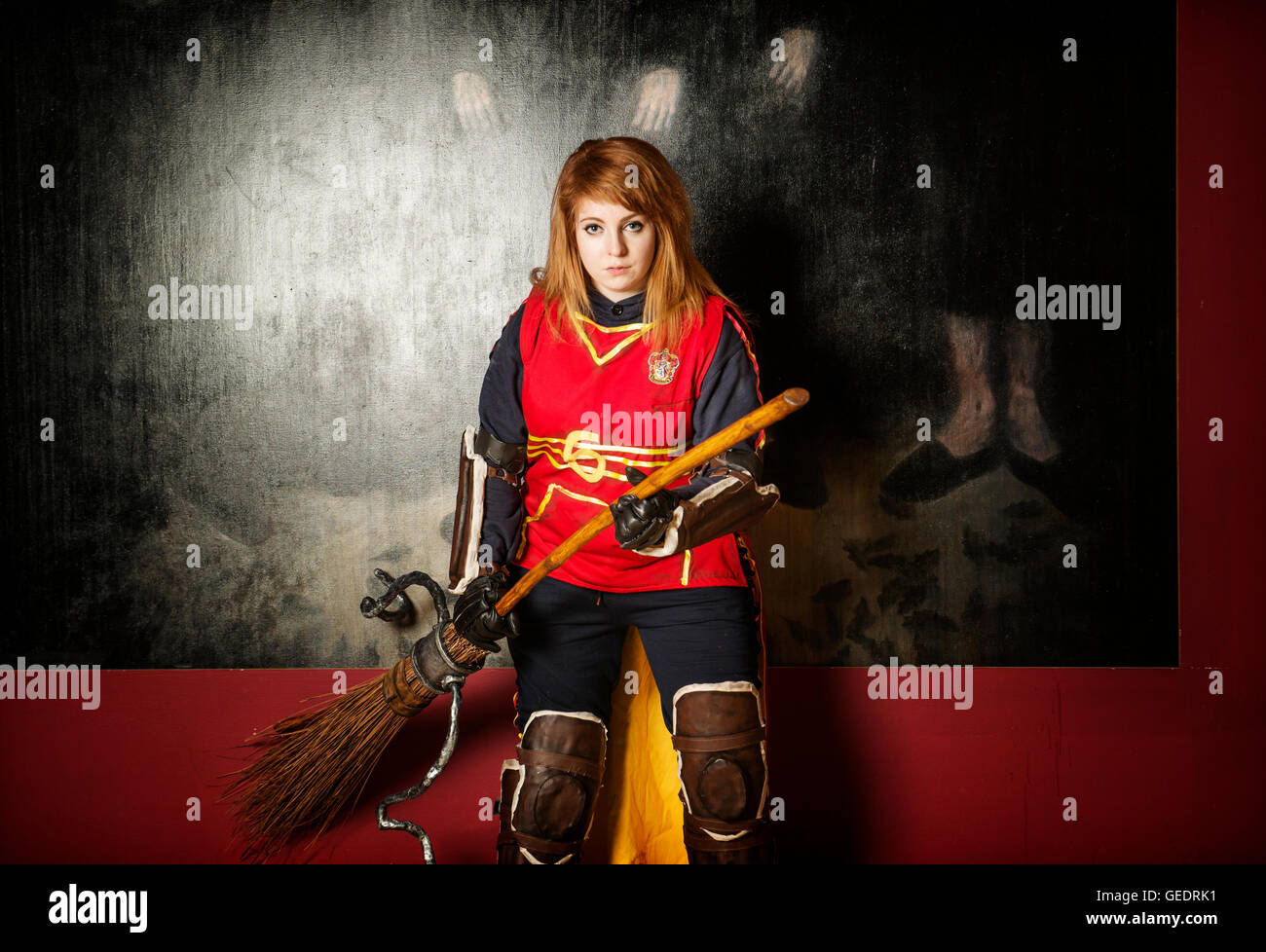 Cosplayer dressed as a Quidditch player from the Harry potter films poses for photographs at a Comic Con convention. Stock Photo
