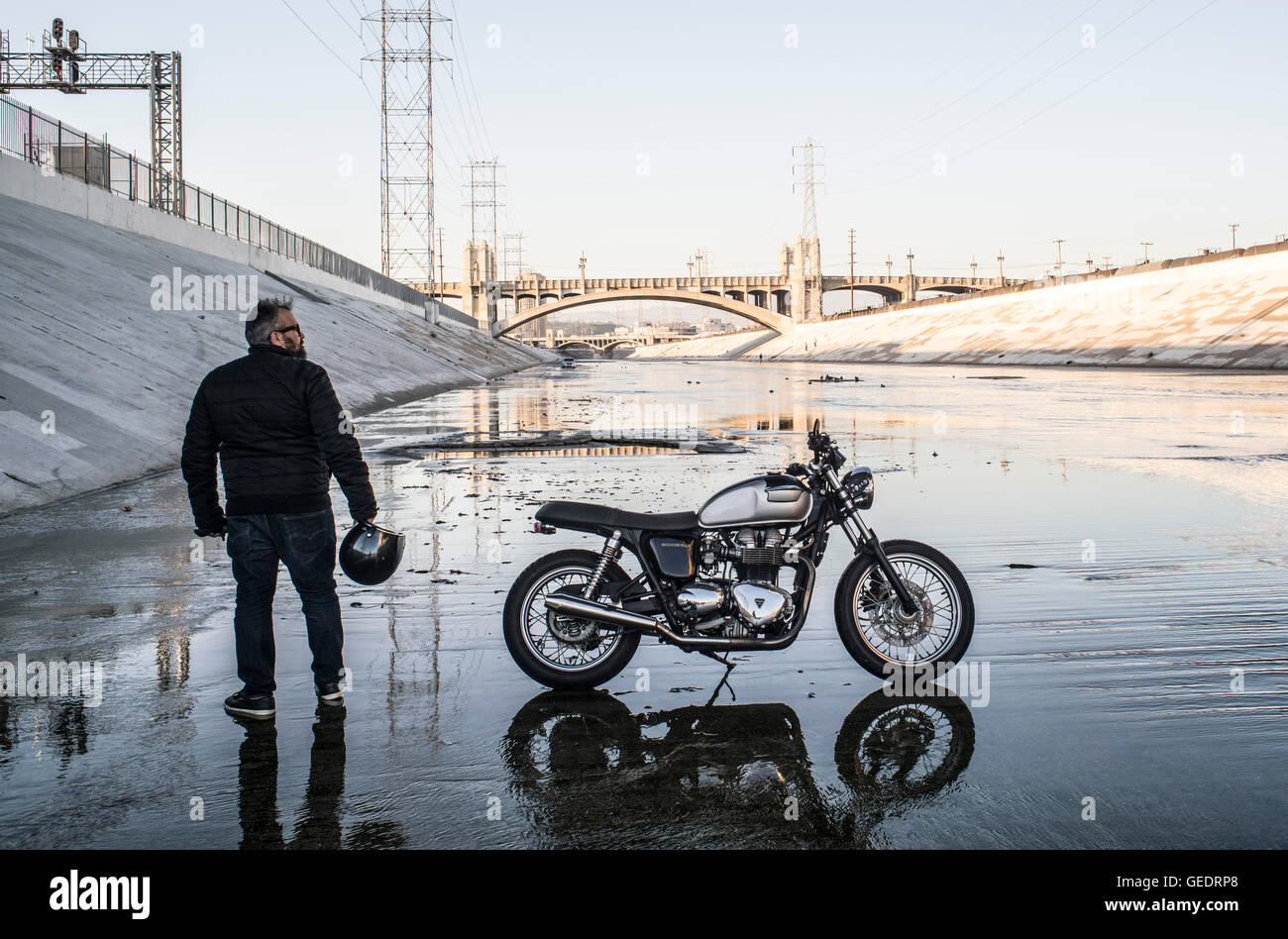 Man Standing with Motorcycle on Los Angeles River, Los Angeles, California, USA Stock Photo