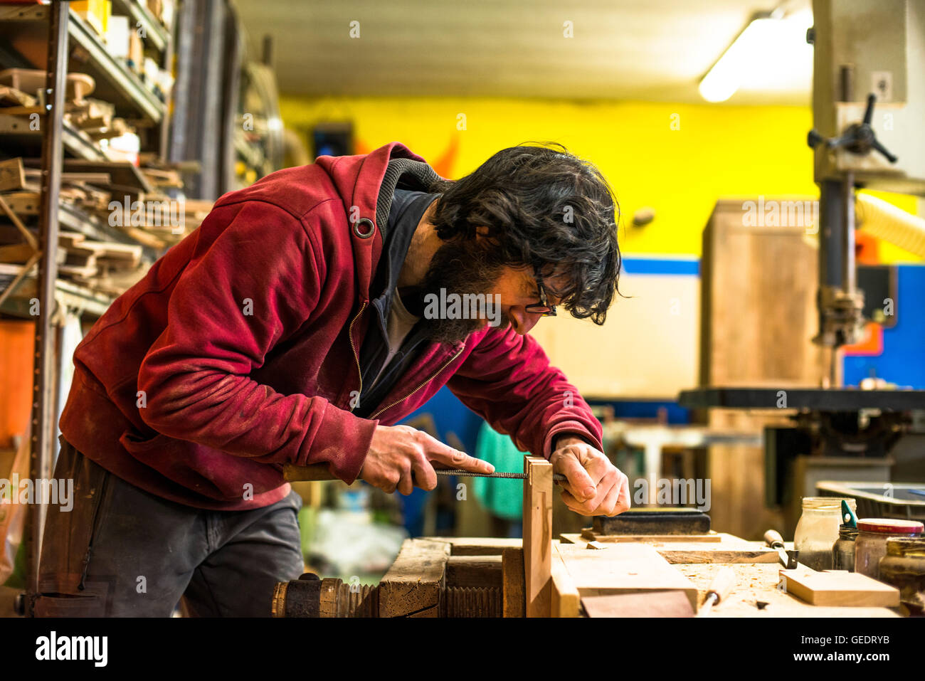 Woodworker Filing Dovetails in Piece of Wood Stock Photo