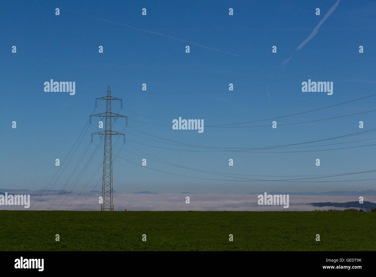 Electricity pylon in landscape with blue sky Stock Photo - Alamy