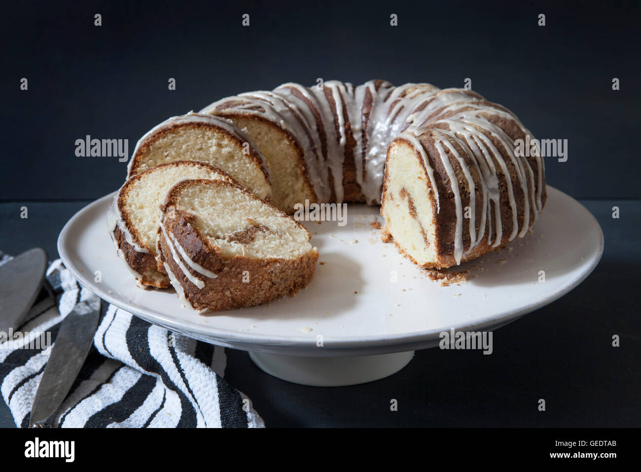 Sliced Sour Cream Coffee Cake with Maple Syrup Glaze on Cake Plate