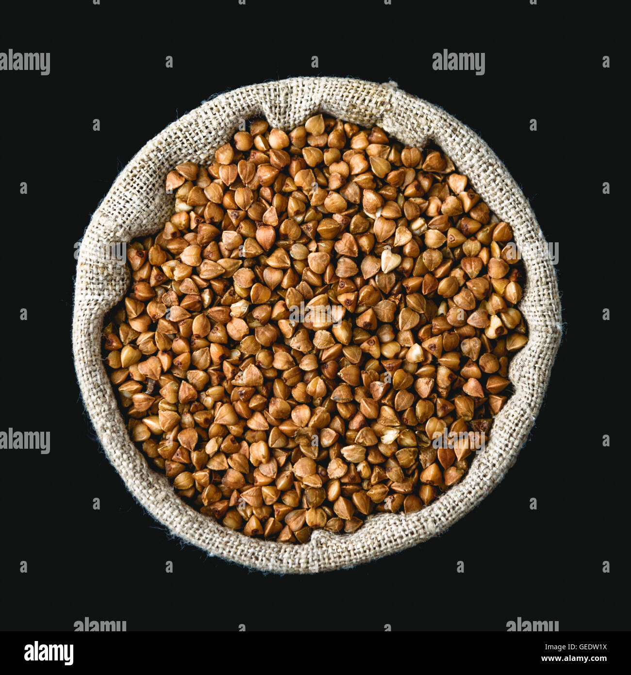 buckwheat in a linen sack isolated on black background Stock Photo