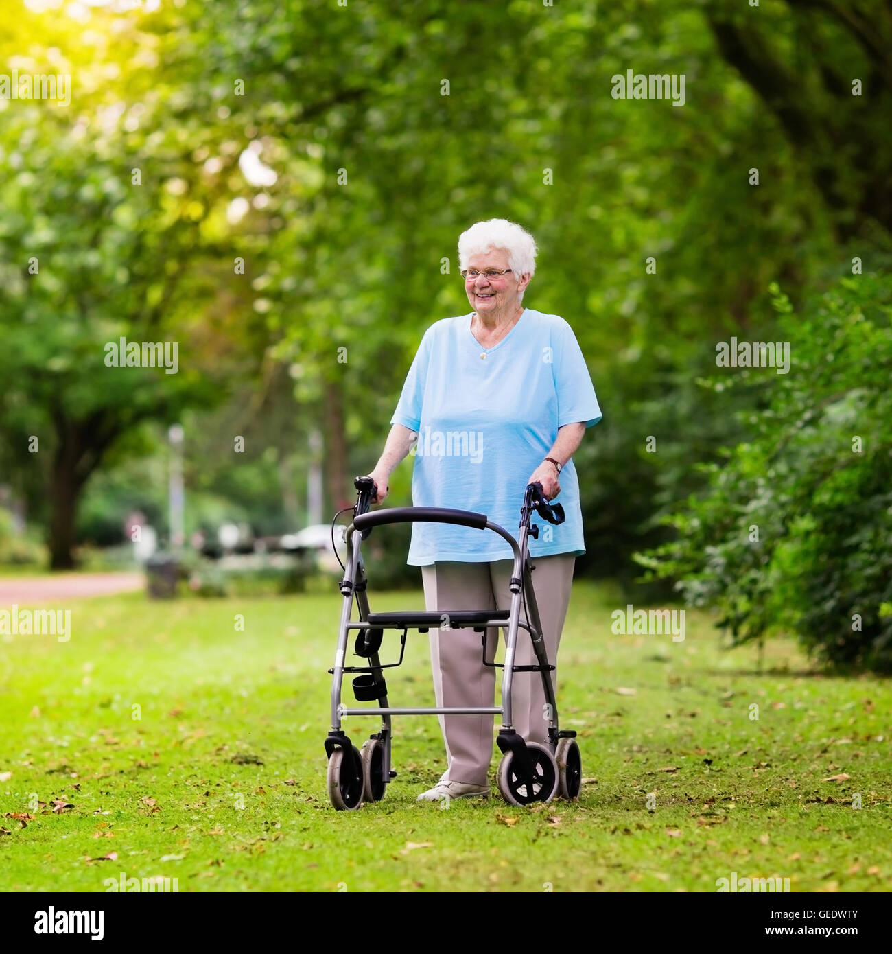 Happy senior handicapped lady with a walking disability enjoying a walk