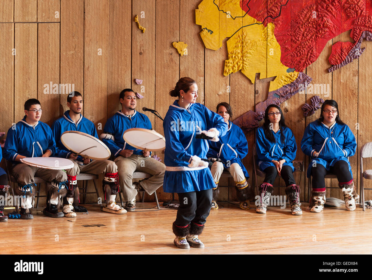 Native Alaskan youth demonstrates the traditional dance of her culture at the Native Alaskan Heritage Center, Anchorage, Alaska. Stock Photo