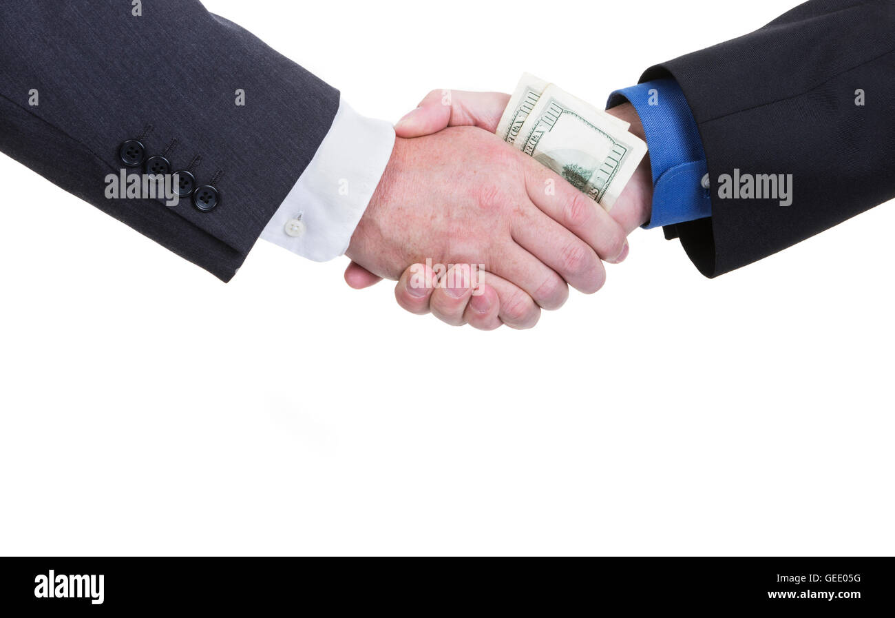 A business handshake with money being exchanged on a white background with copy space. Stock Photo