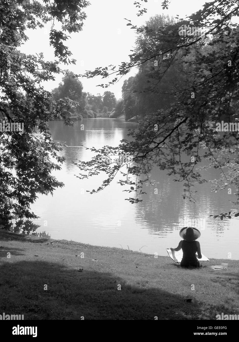 An artist painting a landscape by the lake in Stourhead Garden, Wiltshire, England Stock Photo