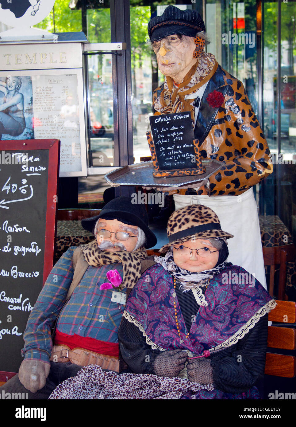 Old couple dolls outside a restaurant in Paris France Stock Photo