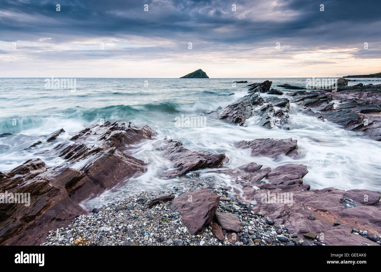 stormy and dramatic clouds over rocky beach in the ocean Stock Photo ...