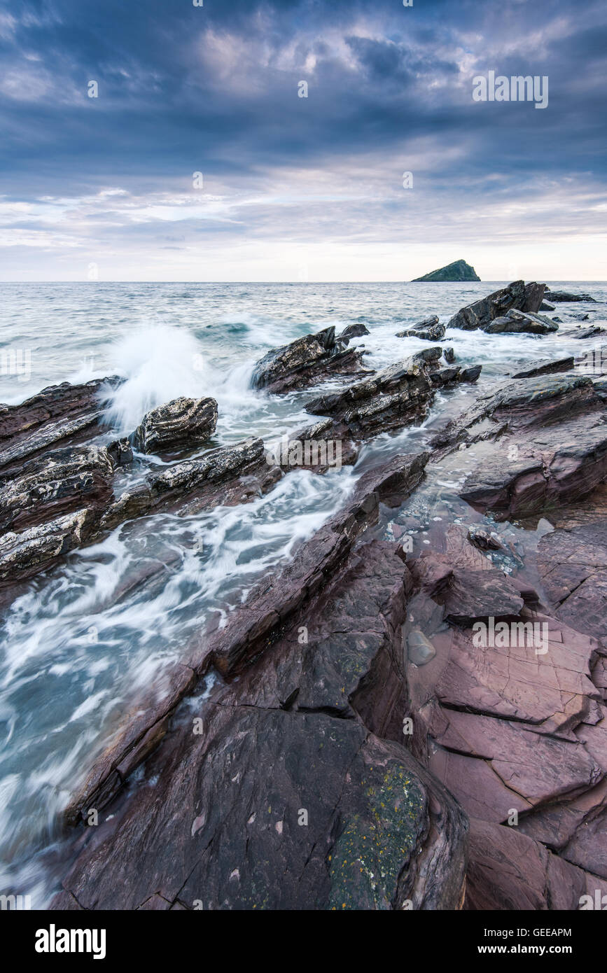 stormy and dramatic clouds over rocky beach in the ocean Stock Photo ...