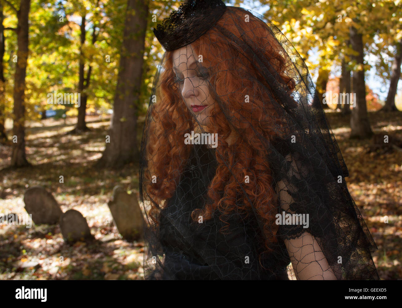 Woman in with black veil in graveyard Stock Photo - Alamy