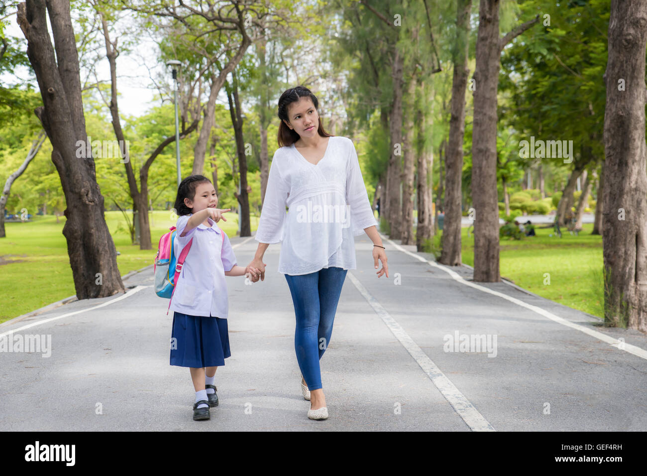 Asian mother and daughter student walking to school.Pupil student. Stock Photo