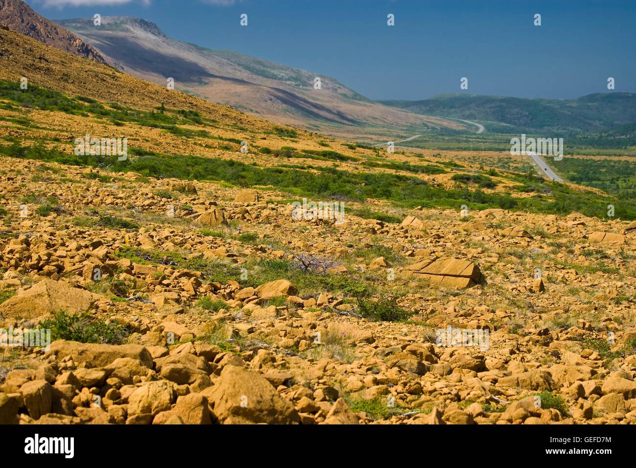 geography / travel, Canada, Newfoundland, View of Highway 431 from a steep hill above the Tablelands Trail in Tablelands showing a contrast between the two sides of the road from rocky to lush and green, Gros Morne National Park, UNESCO World Heritage Sit Stock Photo