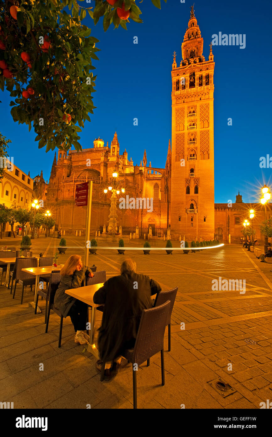 geography / travel, Spain, Andalusia, Seville, Seville Cathedral and La Giralda (bell tower/minaret), a UNESCO World Heritage Site, seen from the Plaza Virgen de los Reyes at dusk, Santa Cruz District, City of Sevilla (Seville), No-Exclusive-Use Stock Photo