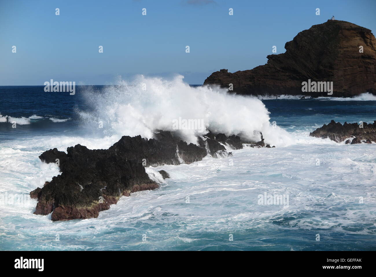 The Atlantic Ocean crashing against volcanic rocks at Porto Moniz on the north west corner of the island of Madeira Stock Photo