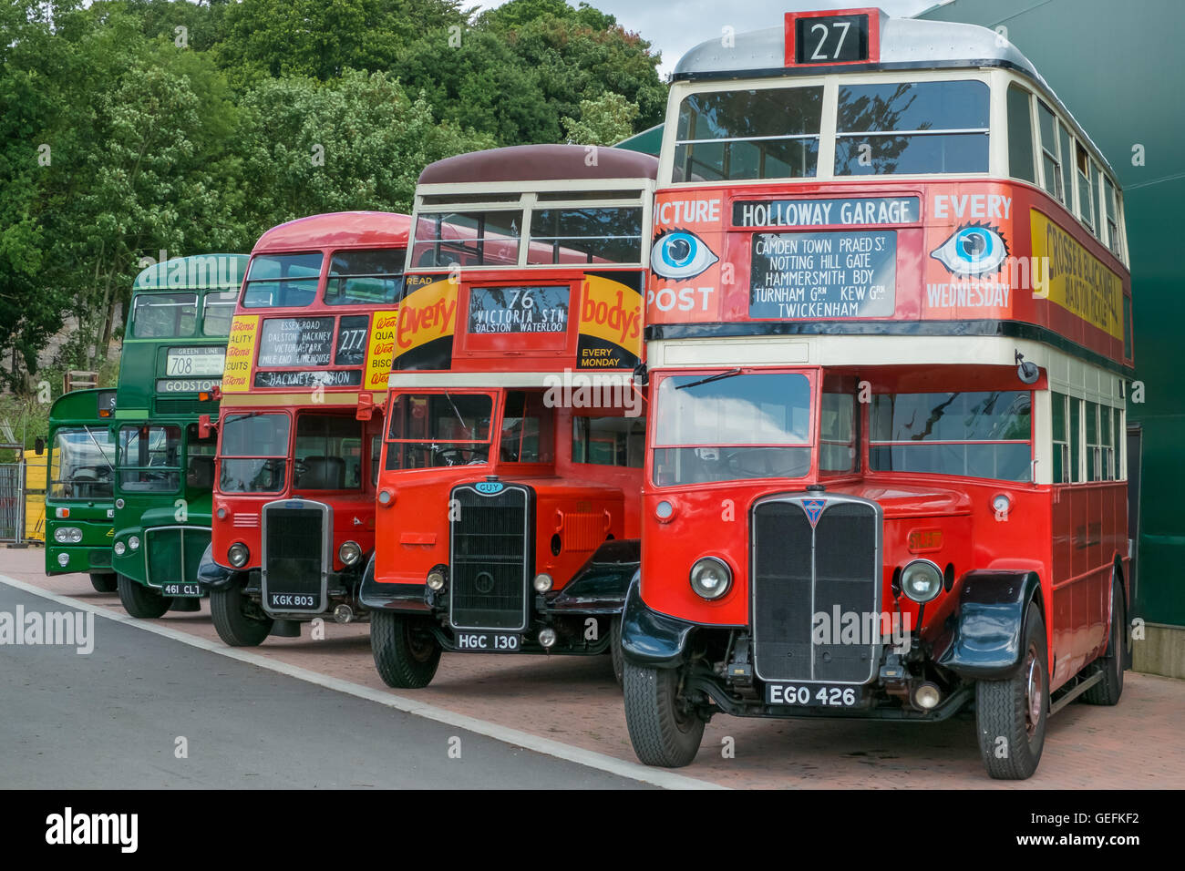 WEYBRIDGE, SURREY, UK - AUGUST 18: A line of vintage red and green vintage London buses. Stock Photo