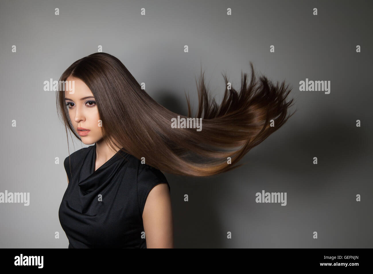 Beautiful model with smooth flying hair Stock Photo