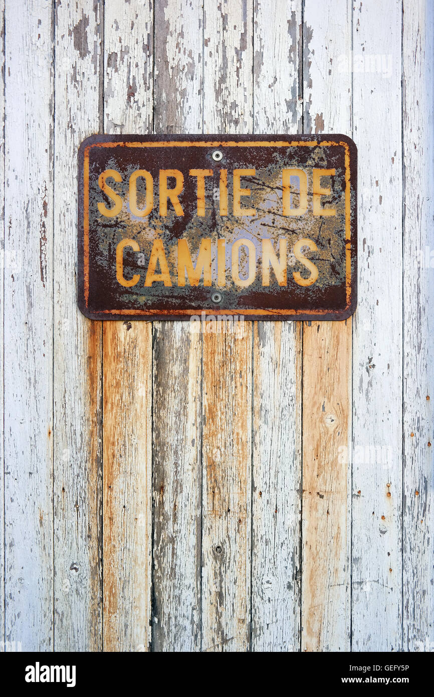Weathered Sign: Sortie de Camions - Trucks output. Stock Photo