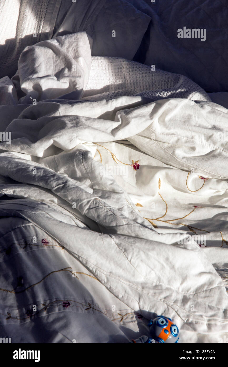 unmade rumpled bed,messy, unmade, unimportant, white, tables, enlighten, drape, wrong, j Stock Photo