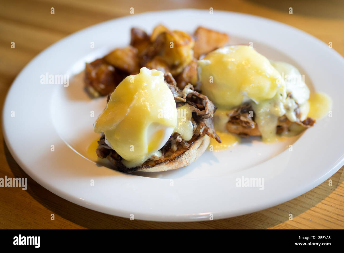 Prime rib eggs benedict with potatoes for breakfast. Stock Photo