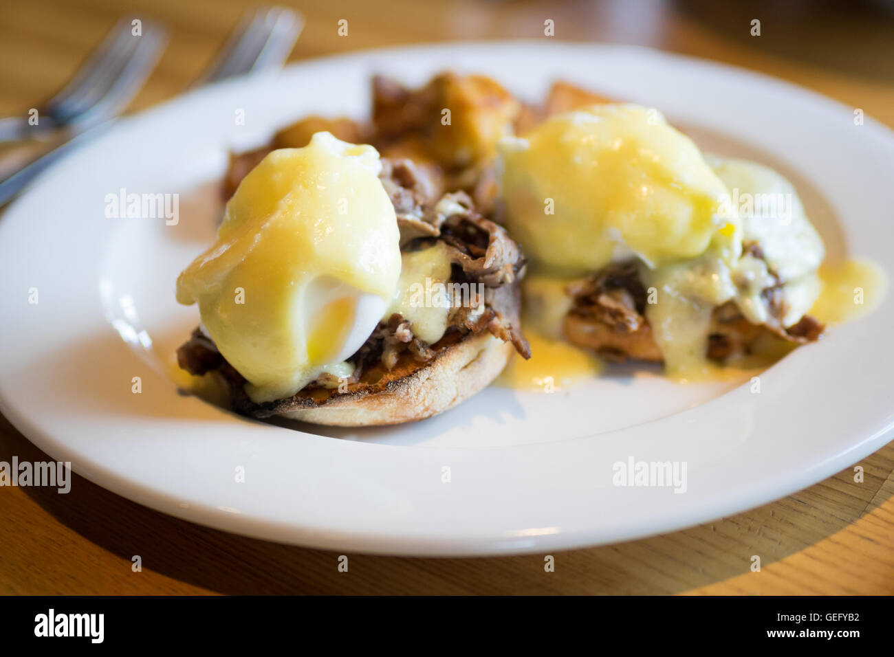Prime rib eggs benedict with potatoes for breakfast. Stock Photo