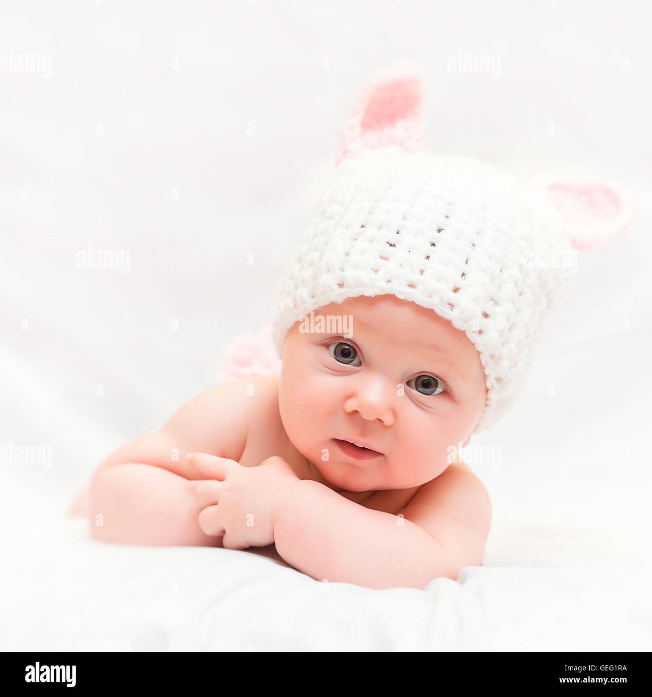 portrait of femail newborn with bunny woolen hat Stock Photo