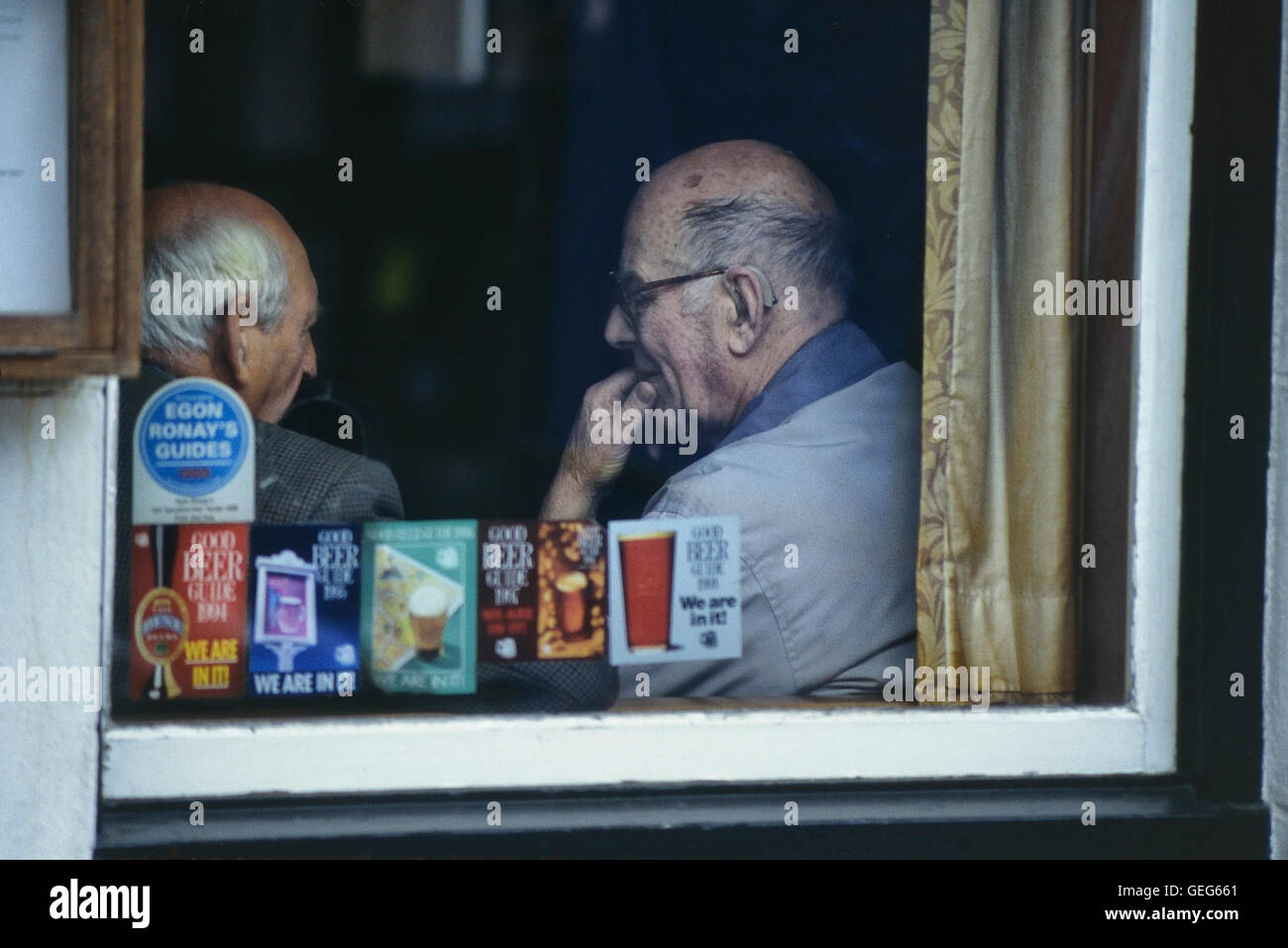 Two elderly men talking in a pub. England. UK Stock Photo