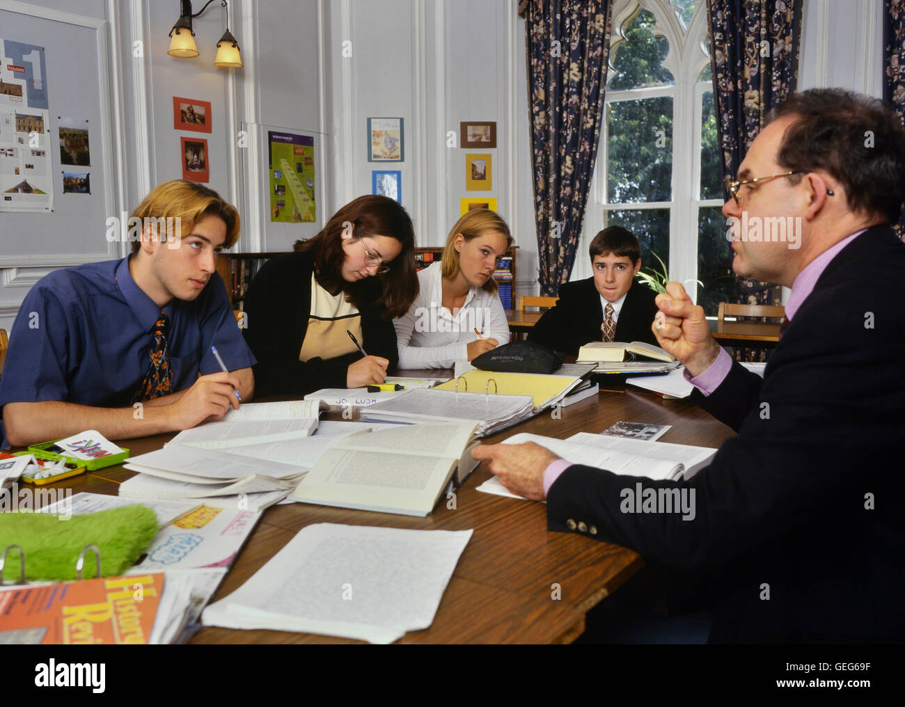 6th form students studying with a teacher. England. Europe Stock Photo