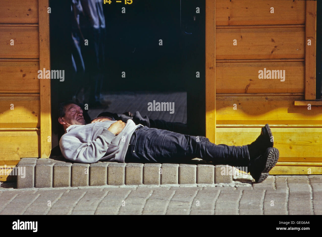 Sleeping man in the doorway of a vodka store. Zakopane. Poland. Stock Photo
