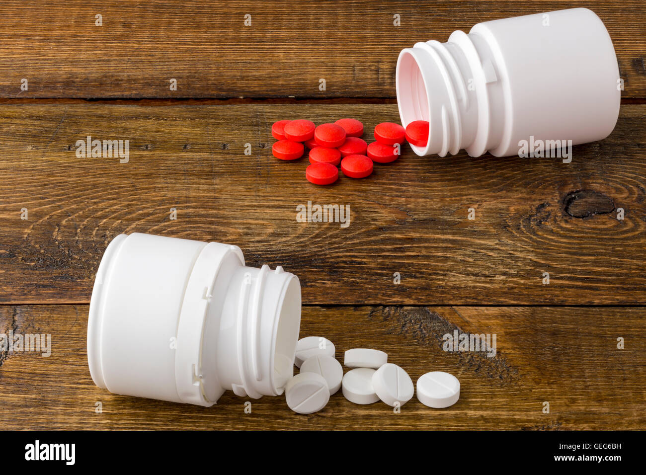Various medical apothecary bottles with colorful pills Stock Photo