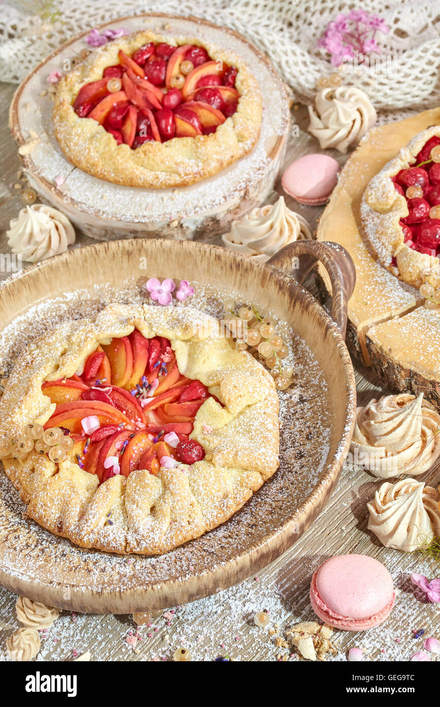 Set of rustic fruit tarts and meringues, homemade pastry. Stock Photo