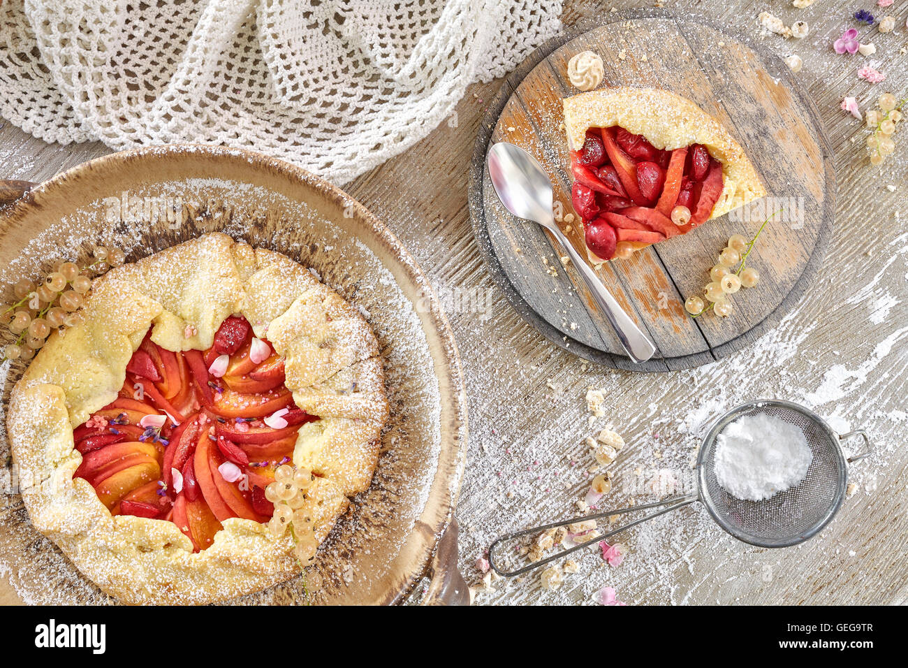 Top view of rustic fruit tarts on a wooden table, homemade pastry. Stock Photo