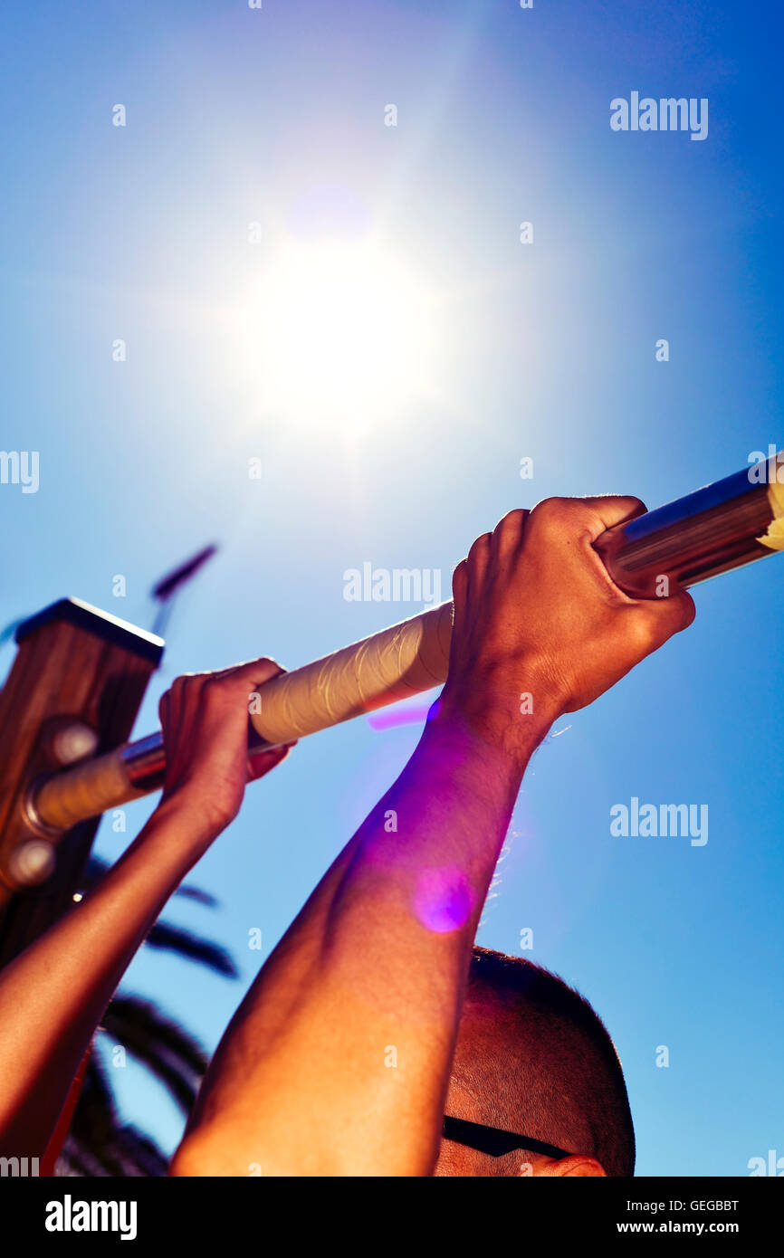 closeup of a young caucasian sportsman wearing sunglasses doing pull-ups outdoors Stock Photo