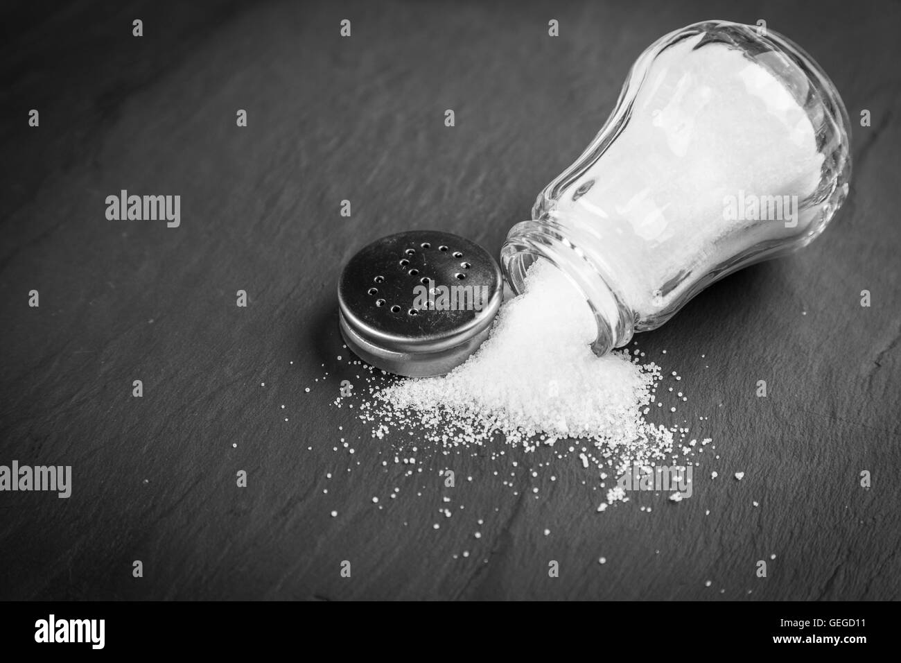 Salt shaker on slate board Stock Photo Alamy