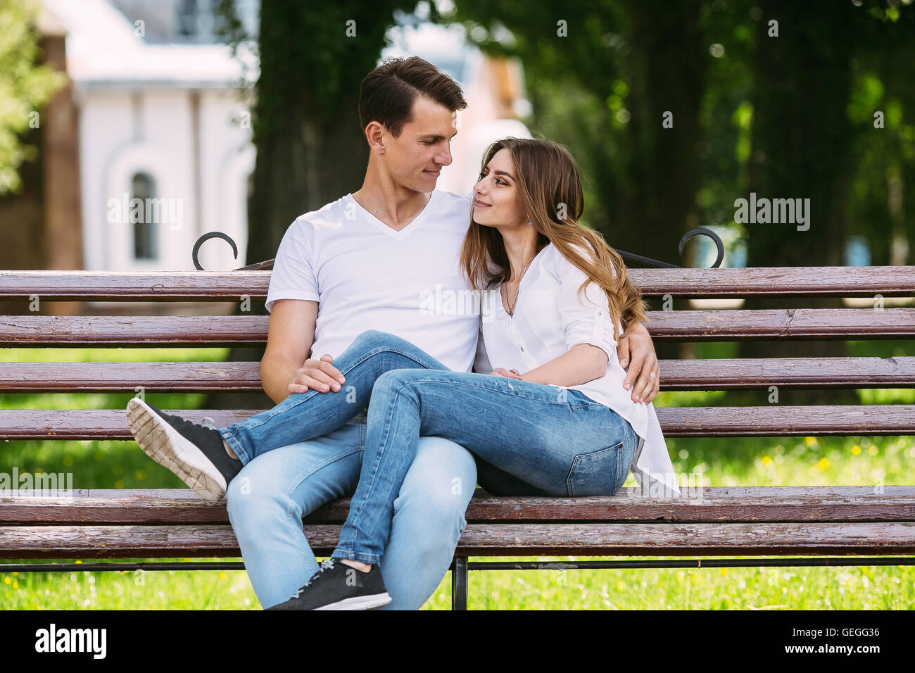 man and woman on a bench in the park Stock Photo - Alamy