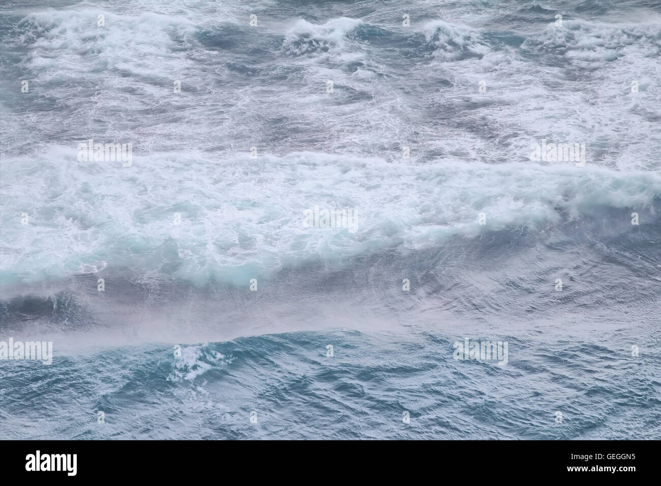 High sharp waves in the Arctic sea. On the horizon of the Northern island of Novaya Zemlya Stock Photo