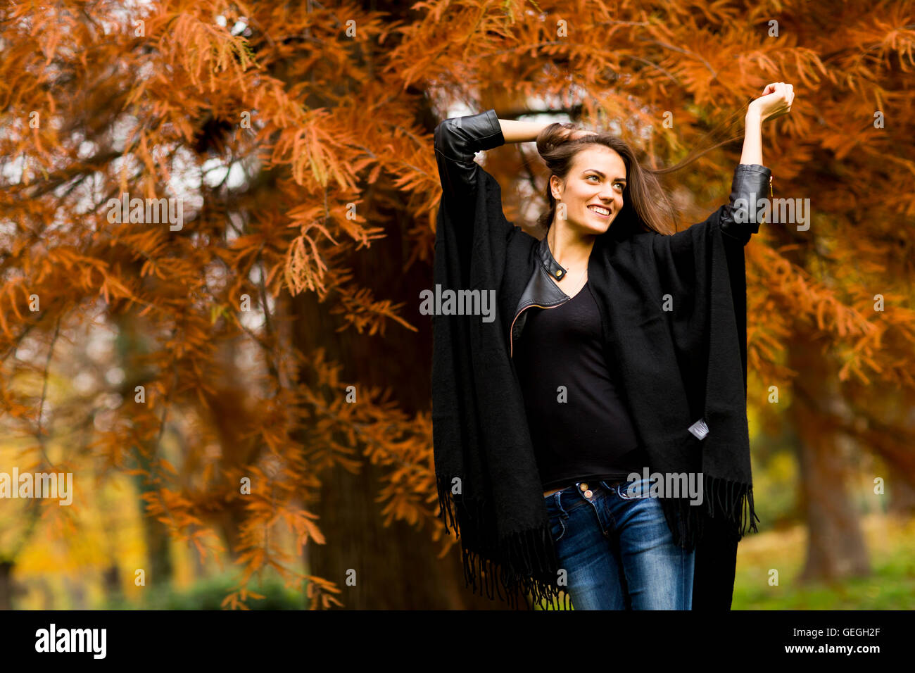 Young woman posing in the autumn park Stock Photo - Alamy