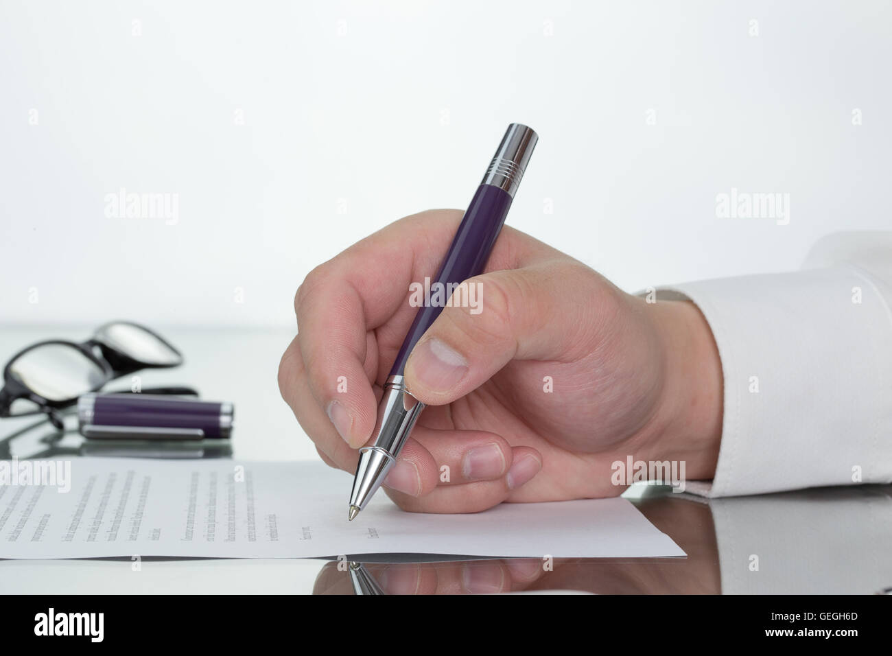 Hand with pen over application form, Businessman signing a contract with ballpoint concept. Stock Photo