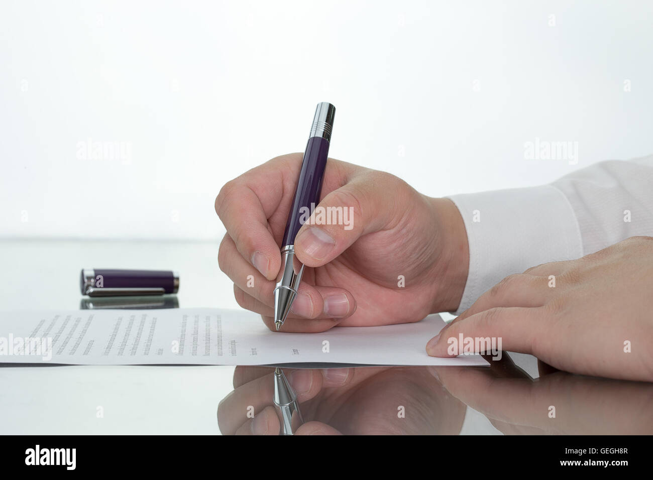 Hand with pen over application form, Businessman signing a contract with ballpoint concept. Stock Photo