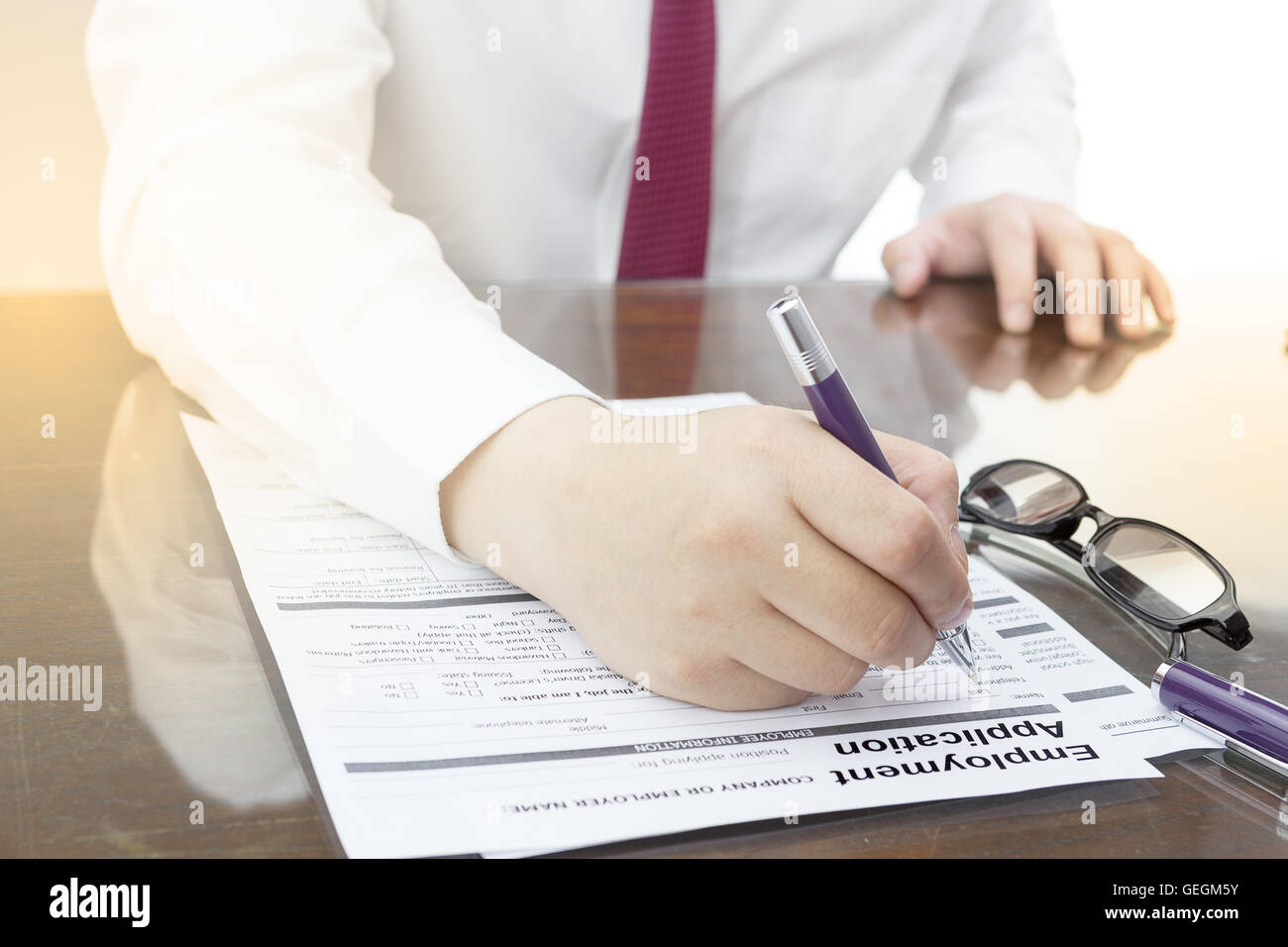 Businessman fill in Employment Application form with pen. job vacancy concept or business employment concept. Stock Photo